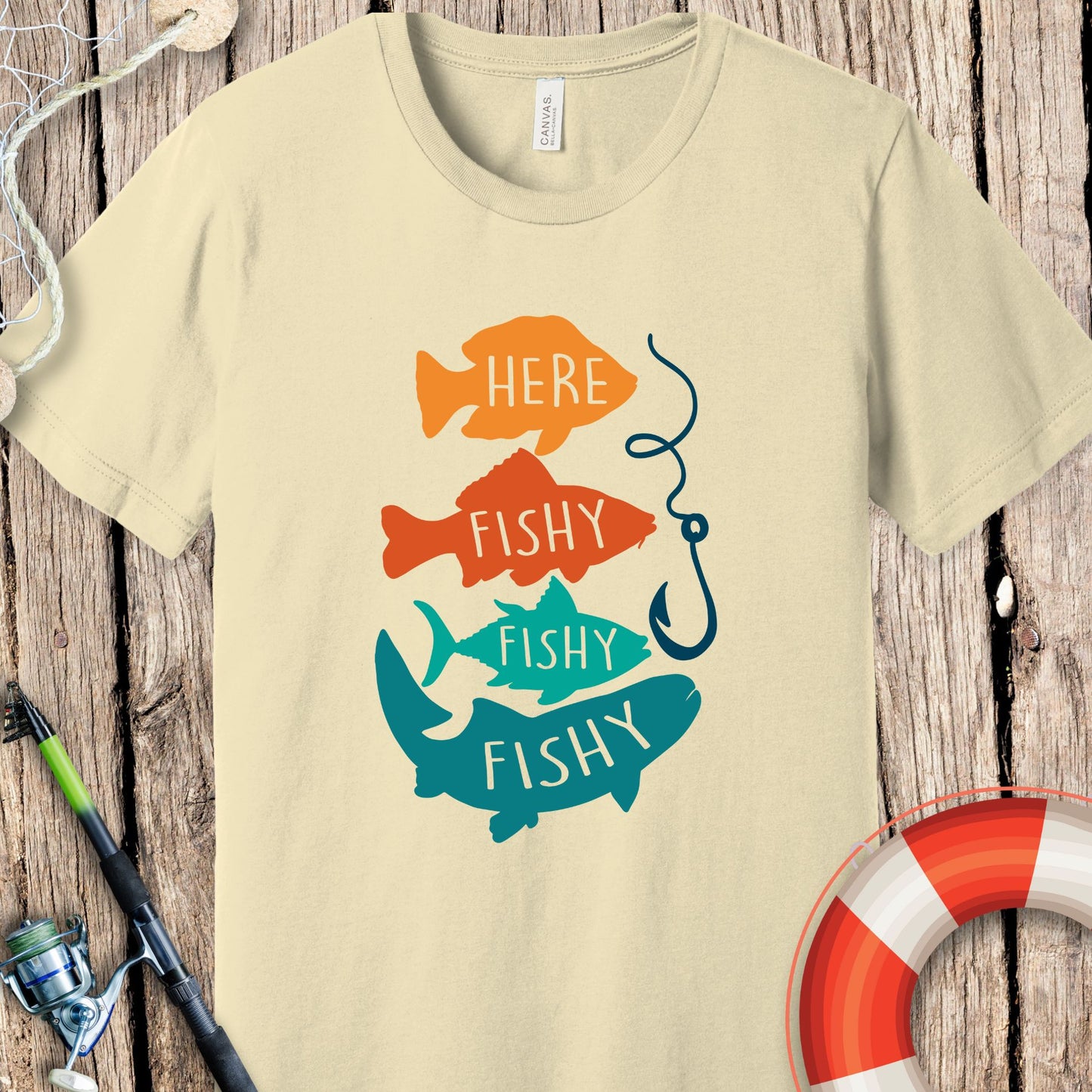 Printify fishing t-shirt with colorful fish graphic and fishing hook on beige background