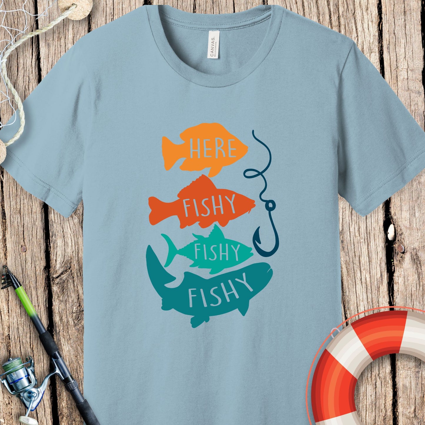 Light blue Printify fishing t-shirt with colorful fish graphic and fishing hook design