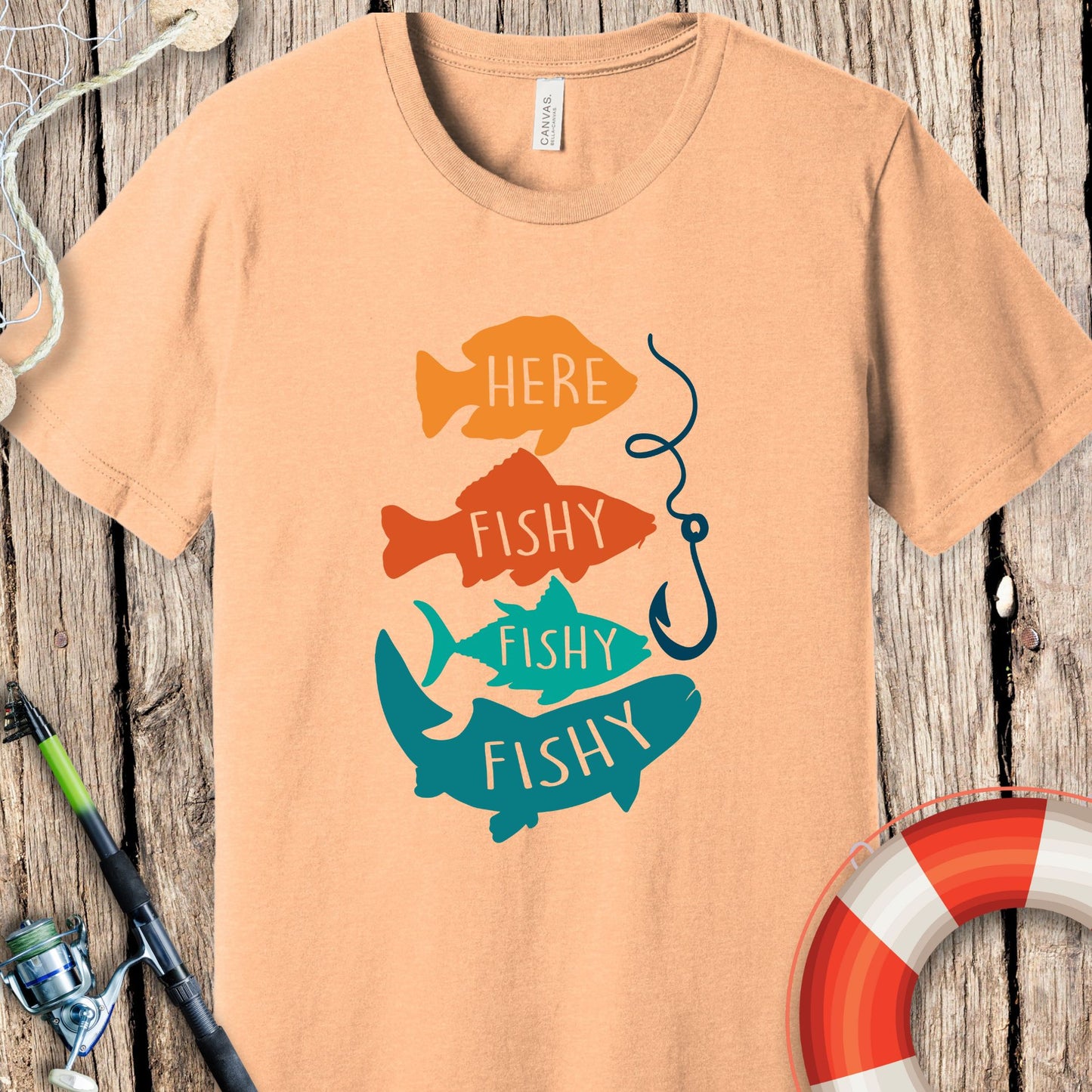 Peach Printify fishing t-shirt with colorful fish graphic and fishing hook design