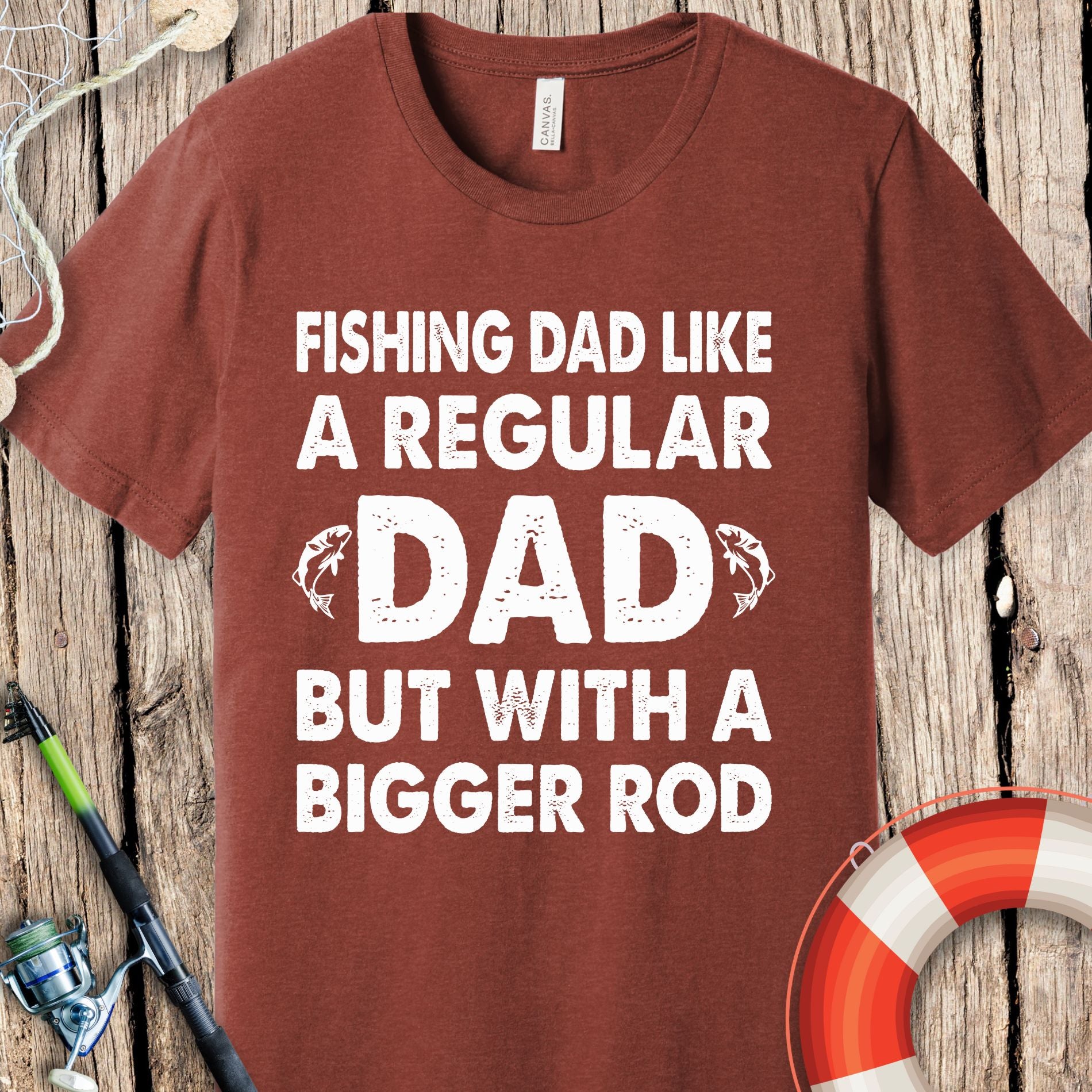 Brown Printify fishing t-shirts for dad with white text reading fishing dad like a regular dad but with a bigger rod