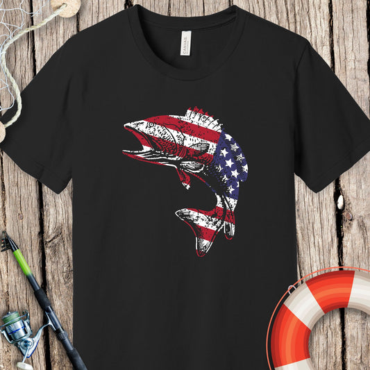 Black Printify fishing t-shirts featuring a fish with an American flag design on a wooden background